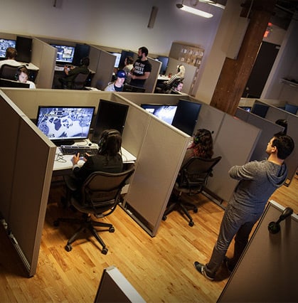 players playing and testing video games at cubicles in the Ubisoft Toronto Playtest Lab