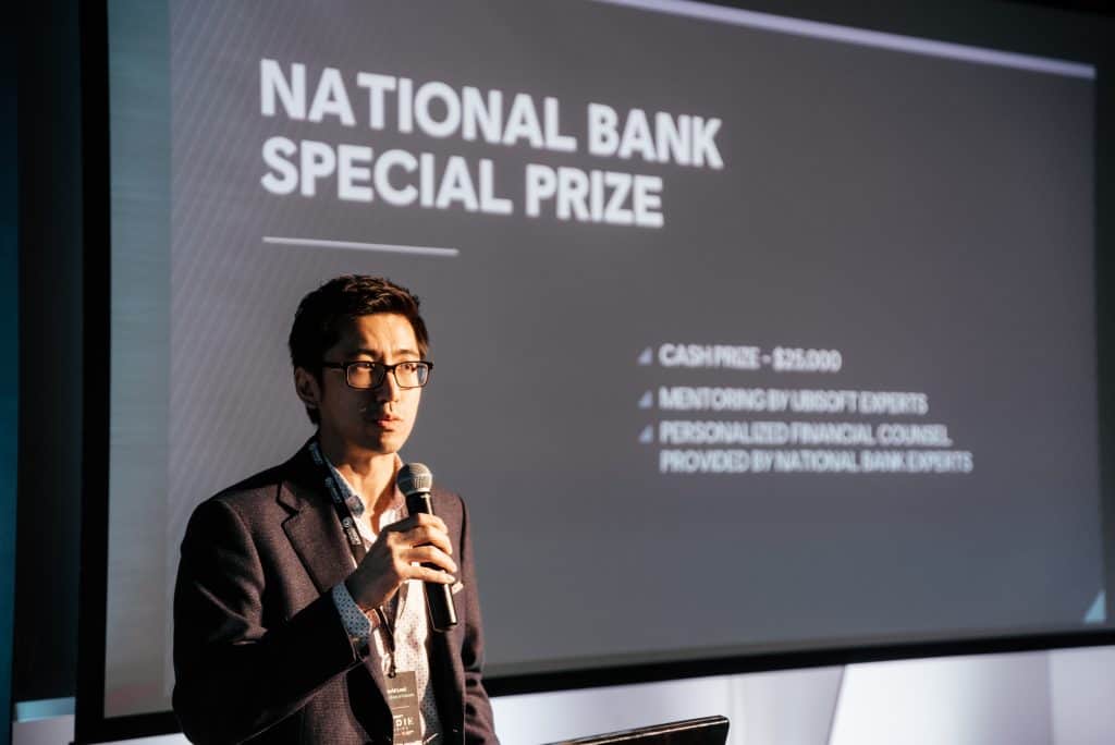 Winners of the Ubisoft Indies Series National Bank Special prize hold award with National Bank representative