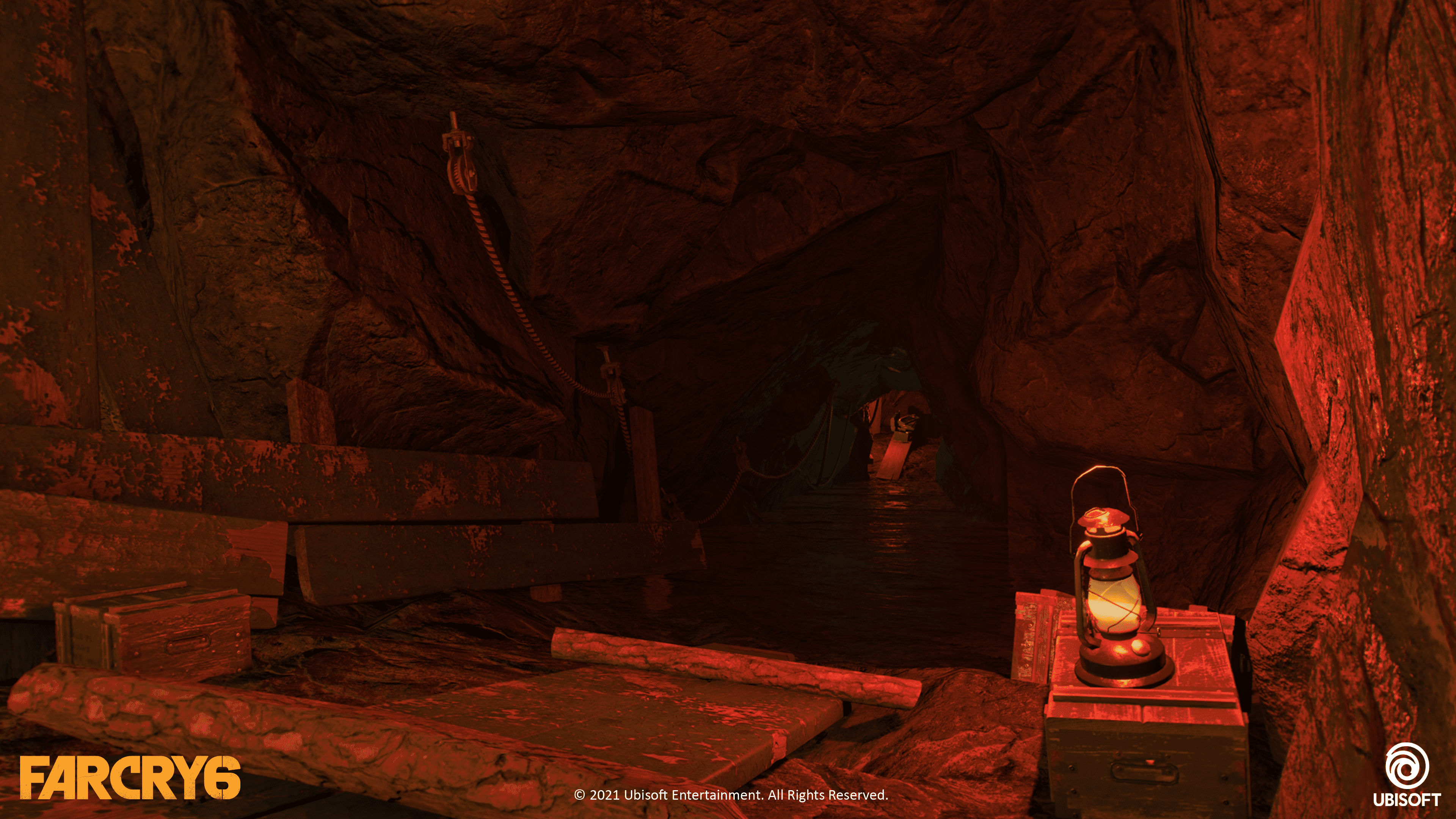 Cave lit in red light from lamp with underground stream